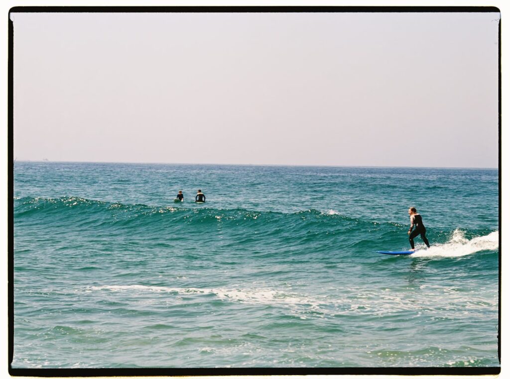 People Surfboarding on the Sea