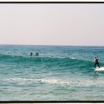People Surfboarding on the Sea