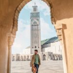 Man Standing Under An Arch Of Building